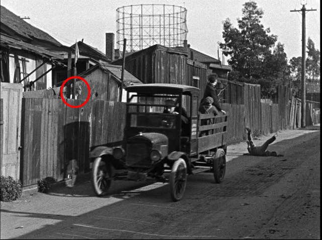 This neighbor suddenly peeks over the fence as the orphanage truck travels west down Labory Lane.